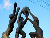 statues of people playing ball