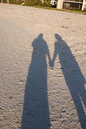 shadows of two people holding hands