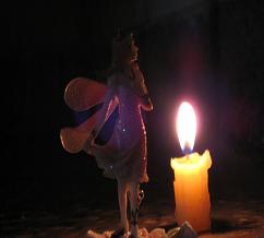 Angelic fairy being and a candle flame