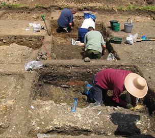 Archaeologists digging at excavation site