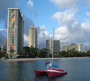 Red boat in city on lake in Waikiki